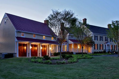Large transitional beige two-story wood house exterior idea in DC Metro with a mixed material roof