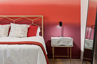 Example of a trendy concrete floor and gray floor bedroom design in Phoenix with multicolored walls