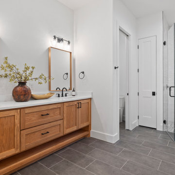 Modern Lakeside Farmhouse Master Bath with Wood Vanity and Frameless Shower