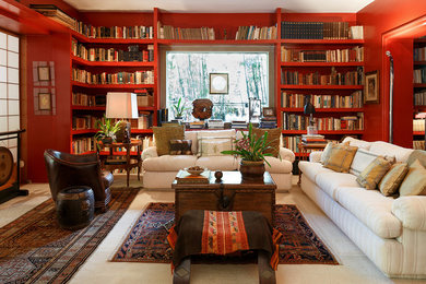 This is an example of a mid-sized eclectic enclosed living room in Other with a library, red walls and carpet.