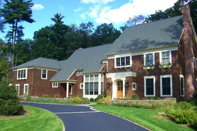 Example of a large arts and crafts brown two-story wood exterior home design in New York with a shingle roof