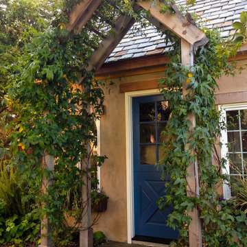 Vine-covered entry arbor at Pebble Beach garden studio
