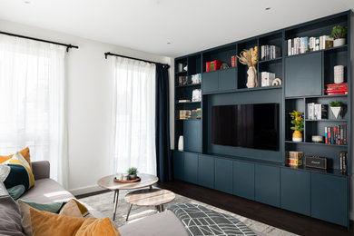 Inspiration for a medium sized contemporary open plan living room in London with white walls, vinyl flooring, a built-in media unit and brown floors.