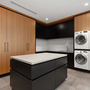 Design ideas for a contemporary l-shaped utility room in Perth with a double-bowl sink, flat-panel cabinets, medium wood cabinets, a side by side washer and dryer, grey floors and white worktops.