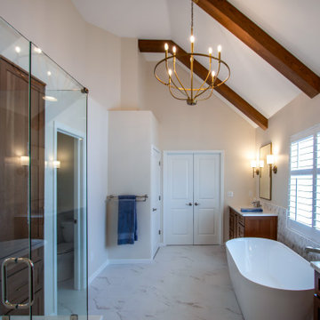 Luxury Spa Bathroom with Natural Warm Vanities, Quartz Countertop, Tiled Shower