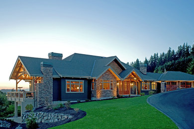This is an example of a large country two-storey green exterior in Seattle with mixed siding.