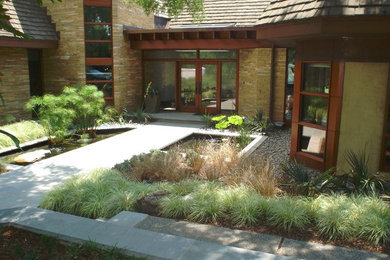 Inspiration for a mid-sized asian partial sun front yard concrete paver pond in Richmond.