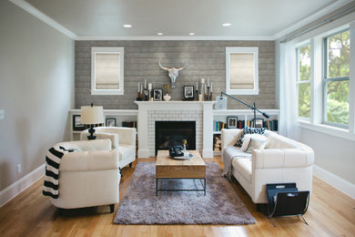 Example of a southwest family room design in New York with gray walls and a standard fireplace