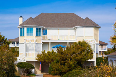 Large coastal yellow two-story wood house exterior idea in Other with a gambrel roof and a shingle roof