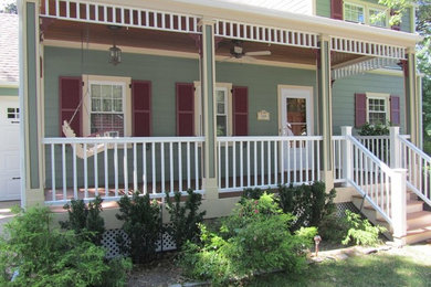 Inspiration for a mid-sized timeless front porch remodel in New York with decking and a roof extension