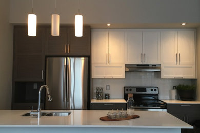 Eat-in kitchen - mid-sized transitional single-wall ceramic tile eat-in kitchen idea in Ottawa with a double-bowl sink, shaker cabinets, dark wood cabinets, solid surface countertops, white backsplash, ceramic backsplash, stainless steel appliances and an island