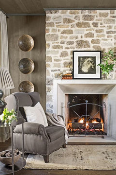 Off Center 70s Stone Floor-to-Ceiling Fireplace & Chandelier Placement