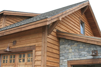 Large mountain style three-story mixed siding exterior home photo in Other with a mixed material roof