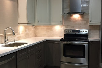 Enclosed kitchen - mid-sized contemporary u-shaped ceramic tile and beige floor enclosed kitchen idea in Toronto with an undermount sink, recessed-panel cabinets, gray cabinets, solid surface countertops, beige backsplash, stone tile backsplash, stainless steel appliances and a peninsula