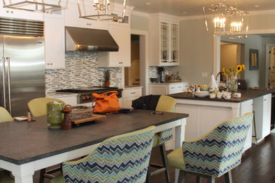 Example of a large transitional galley dark wood floor and brown floor open concept kitchen design in New York with an undermount sink, shaker cabinets, white cabinets, white backsplash, stainless steel appliances and two islands