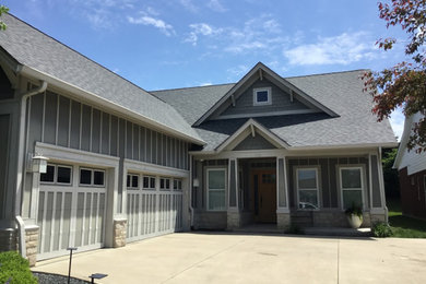 Example of a gray exterior home design in Indianapolis with a hip roof, a shingle roof and a gray roof