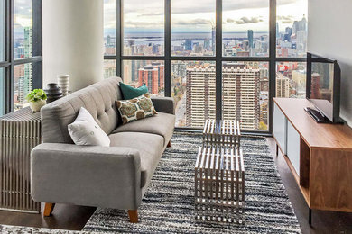 Example of a small 1950s loft-style dark wood floor living room design in Toronto with white walls, no fireplace and a tv stand