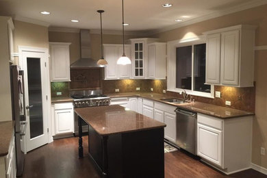 Open concept kitchen - large traditional u-shaped dark wood floor open concept kitchen idea in San Diego with a double-bowl sink, raised-panel cabinets, white cabinets, granite countertops, brown backsplash, ceramic backsplash, stainless steel appliances and an island