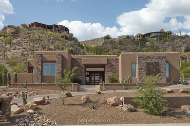 Photo of a contemporary one-storey stucco beige exterior in Phoenix.