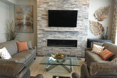 Photo of a contemporary formal enclosed living room in Other with grey walls, dark hardwood floors, a ribbon fireplace, a stone fireplace surround, a wall-mounted tv and brown floor.