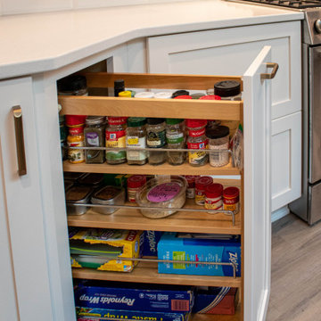 3 Finishes on Kitchen Cabinetry with Galley Workstation in Island and Wine Bar