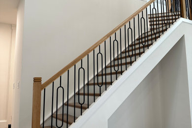 Photo of a medium sized modern wood straight mixed railing staircase in Miami with painted wood risers.