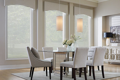 Large trendy light wood floor enclosed dining room photo in New York with white walls and no fireplace
