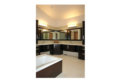 Large trendy master multicolored tile and mosaic tile marble floor and white floor drop-in bathtub photo in Denver with flat-panel cabinets, black cabinets, quartz countertops, white walls and a drop-in sink