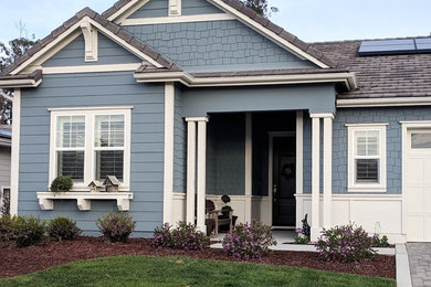 Large farmhouse blue house exterior idea in San Luis Obispo with a clipped gable roof and a shingle roof