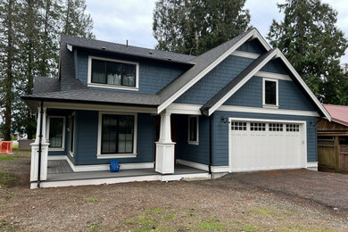 Mid-sized trendy blue two-story concrete fiberboard and shingle exterior home photo in Vancouver with a shingle roof and a black roof