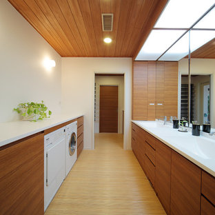 Design ideas for a modern utility room in Tokyo with an integrated sink, flat-panel cabinets, medium wood cabinets, white walls and brown floors.