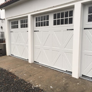 Example of a mid-sized minimalist attached three-car garage design in New York