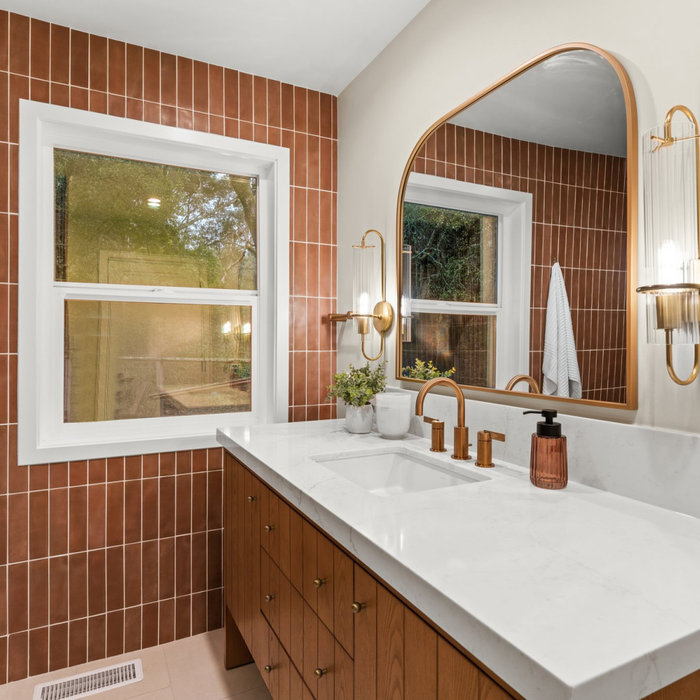 Mid-sized transitional trendy orange ceramic porcelain tile, marbled counter with single-sink bathroom photo with light wood cabinets, and modern mirror and fixtures.
