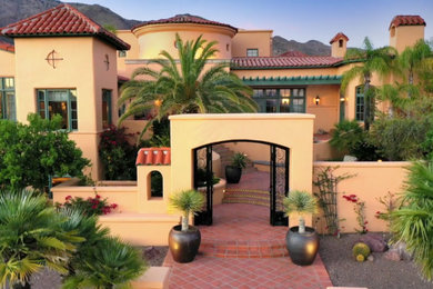 Mediterranean two-story stucco house exterior idea in Phoenix with a red roof