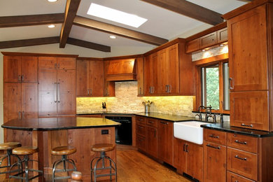 Example of a large transitional l-shaped dark wood floor eat-in kitchen design in Denver with a farmhouse sink, flat-panel cabinets, dark wood cabinets, granite countertops, beige backsplash, stainless steel appliances and an island