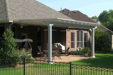 Inspiration for a small timeless backyard brick patio remodel in Other with a pergola