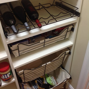 Mid-sized traditional kitchen pantry inspiration - Inspiration for a mid-sized timeless single-wall kitchen pantry remodel in Manchester with flat-panel cabinets, white cabinets and no island