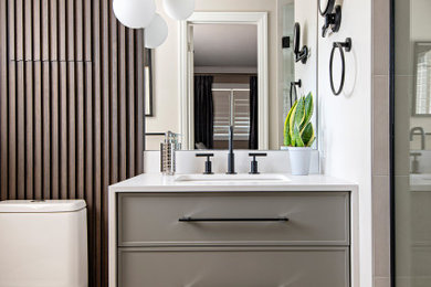 Bathroom - mid-sized contemporary white tile and ceramic tile ceramic tile, gray floor, single-sink and wood wall bathroom idea in Toronto with gray cabinets, a one-piece toilet, white walls, an undermount sink, quartz countertops and white countertops