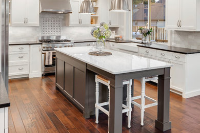 Example of a huge trendy u-shaped eat-in kitchen design in Other with a farmhouse sink, flat-panel cabinets, quartz countertops, gray backsplash, ceramic backsplash, stainless steel appliances and an island