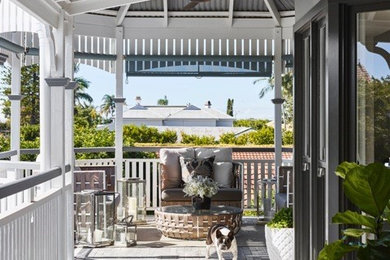 Design ideas for a mid-sized country side yard deck in Brisbane with a roof extension.