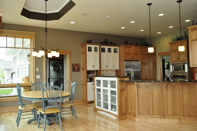 Kitchen/dining room combo - light wood floor kitchen/dining room combo idea in Other with gray walls and no fireplace