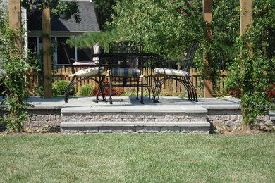 Mid-sized trendy backyard concrete paver patio kitchen photo in Richmond with a pergola