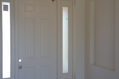 Small traditional front door in Tampa with white walls, ceramic floors, a single front door and a white front door.