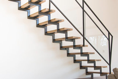 This is an example of an industrial wood straight staircase in Paris.
