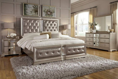 Example of a mid-sized transitional master medium tone wood floor and brown floor bedroom design with gray walls and no fireplace