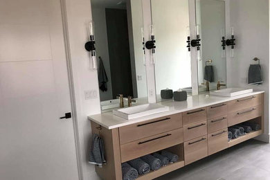 Bathroom - contemporary bathroom idea in Chicago with flat-panel cabinets, light wood cabinets, quartzite countertops and white countertops