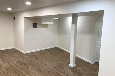 Mid-sized trendy walk-out vinyl floor basement photo in Boston