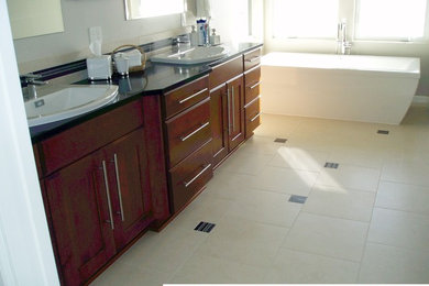 Freestanding bathtub - large transitional master beige tile porcelain tile freestanding bathtub idea in Seattle with a drop-in sink, medium tone wood cabinets, shaker cabinets, white walls and quartz countertops
