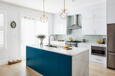 Kitchen - contemporary light wood floor kitchen idea in DC Metro with flat-panel cabinets, turquoise cabinets, green backsplash, stainless steel appliances, an island and white countertops