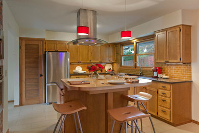 Example of a classic kitchen design in Portland with shaker cabinets, medium tone wood cabinets, wood countertops, yellow backsplash and stainless steel appliances